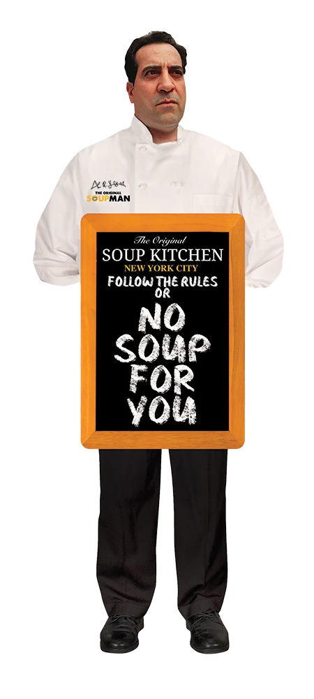A chef in kitchen whites holding a chalkboard: The Original Soup Kitchen, New York City, follow the Rules or No Soup For You